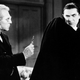 Van Helsing (Edward Van Sloan) holds a cross in front of a recoiling Count Dracula (Bela Lugosi) in 1931's Dracula.